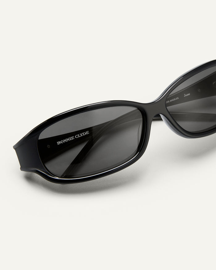 Detail shot of Bonnie Clyde Joans sunglasses in black with black lenses.