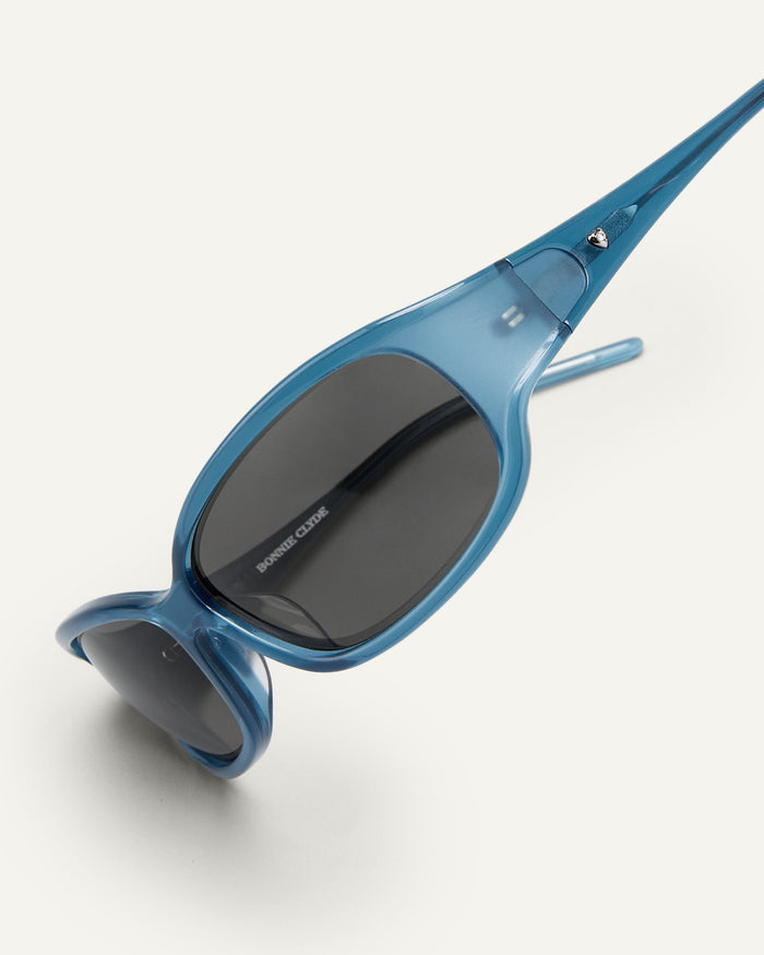 Side shot of Bonnie Clyde Joans sunglasses in blue and black.