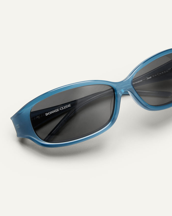 Close up shot of Bonnie Clyde Joans sunglasses in blue and black.