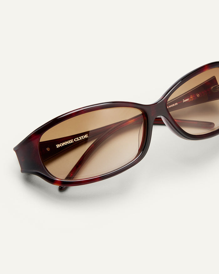 Additional view of Bonnie Clyde Joans sunglasses in red tortoise with brown gradient lenses.