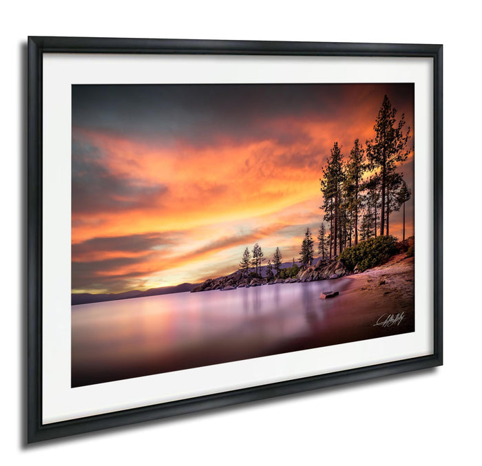 a serene landscape with a calm lake reflecting the vibrant colors of a sunset sky, surrounded by tall trees.