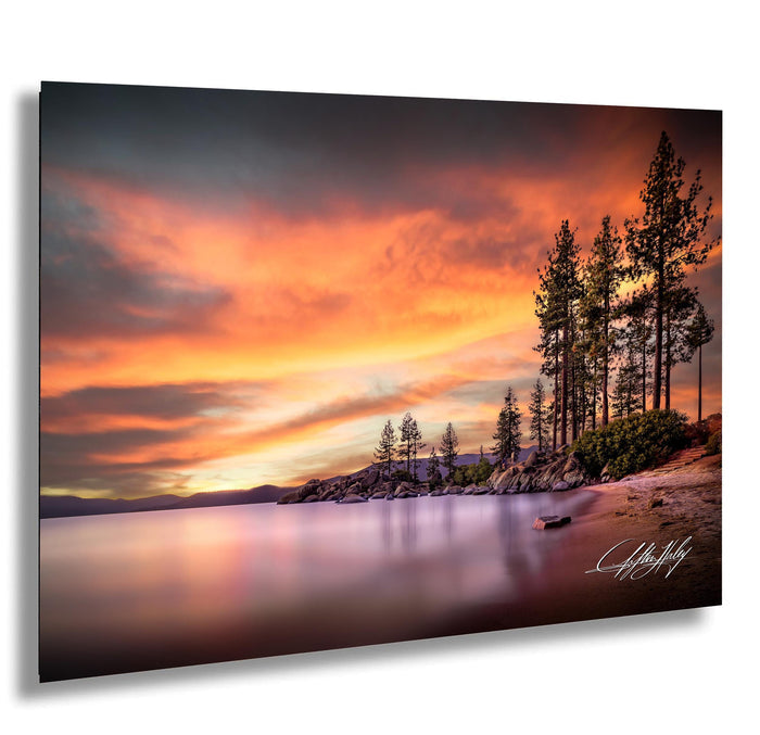 a serene landscape with a calm lake reflecting the vibrant colors of a stunning sunset. The sky is filled with warm hues of orange and pink, creating a breathtaking backdrop for the scene. The lake is surrounded by a line of tall trees, adding a sense of tranquility and natural beauty to the image. The overall composition is visually appealing and evokes a sense of peace and relaxation.