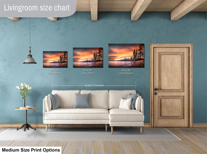 a living room with a white sofa and a wooden door. Above the sofa, there is a livingroom size chart that provides the dimensions of three framed landscape paintings in inches.