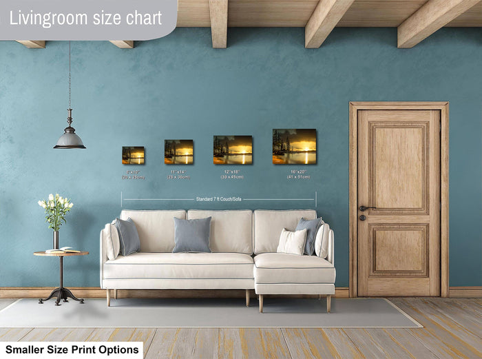 a living room with a white sofa, a wooden door, and a hanging light fixture. Above the sofa, there is a size chart indicating the dimensions of the artwork displayed on the wall.