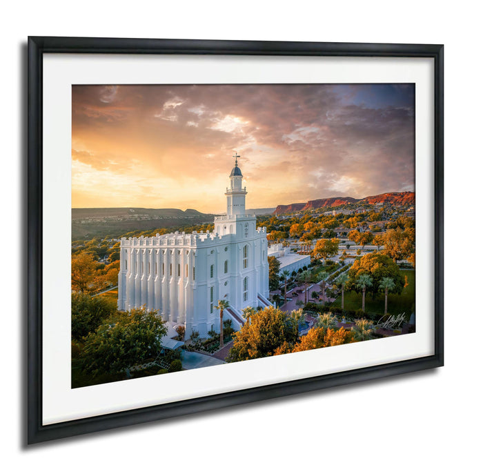 A framed photograph of the White Temple, a prominent landmark in Salt Lake City, Utah, set against a vibrant sunset sky with orange and pink hues.