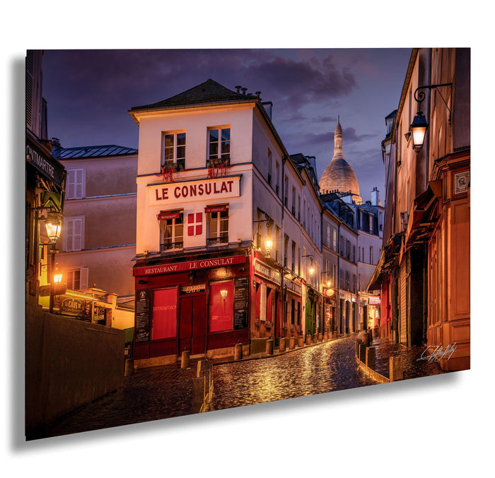 a charming street scene in Paris, France, with a row of colorful buildings lining the cobblestone street, illuminated by warm street lamps and the soft glow of the evening sky.