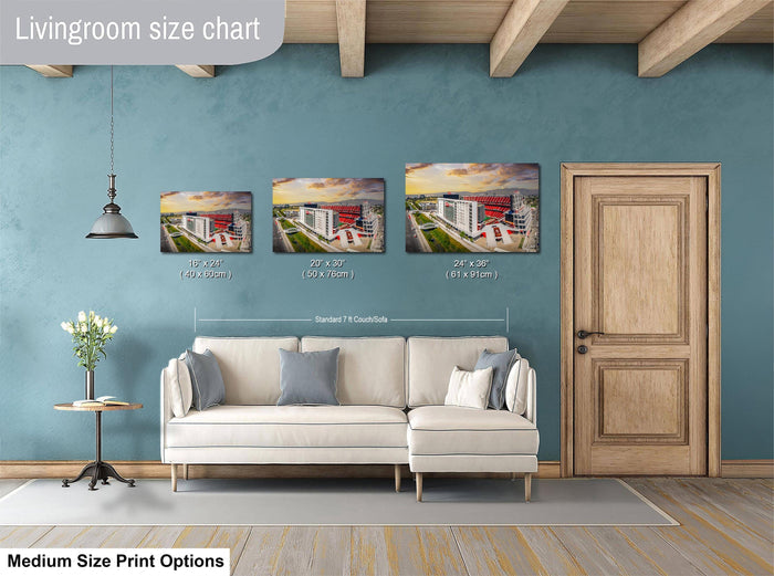 a living room with a white sofa and a wooden door. Above the sofa, there is a livingroom size chart that provides the dimensions of three different paintings or prints displayed on the wall.