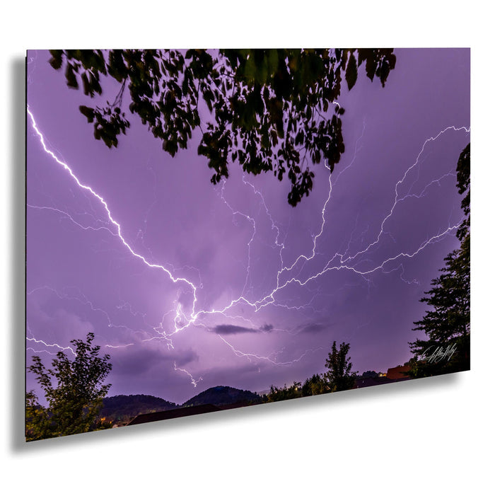 a dramatic lightning storm with bolts of bright light streaking across the dark purple sky, creating a stunning and awe-inspiring scene.