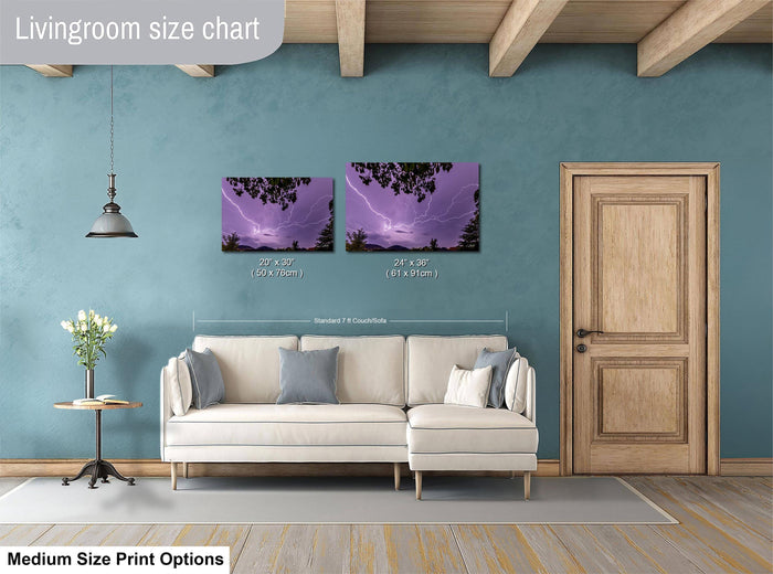 a living room with a white sofa, a wooden door, and a painting of a stormy sky on the wall. The living room appears to be designed for relaxation and comfort, with a cozy and inviting atmosphere.