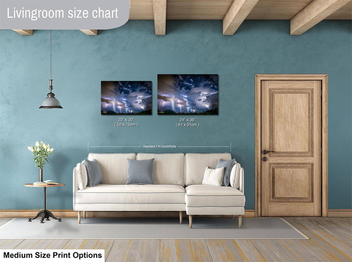 a living room with a white sofa, a wooden door, and a painting of a stormy sky hanging on the wall.
