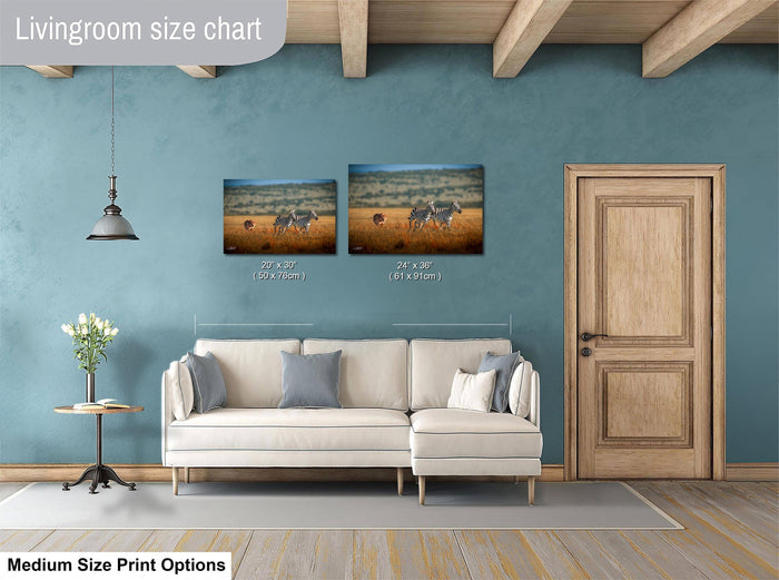 a living room with a white sofa, a wooden door, and a painting of zebras on the wall. The living room has a blue wall and a wooden floor.