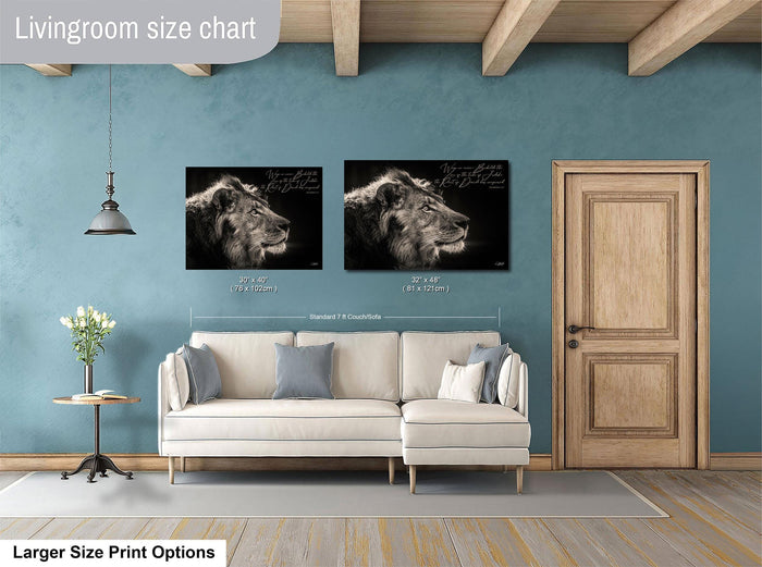 a living room with a white sofa, a wooden door, and two framed black and white lion portraits on the wall.