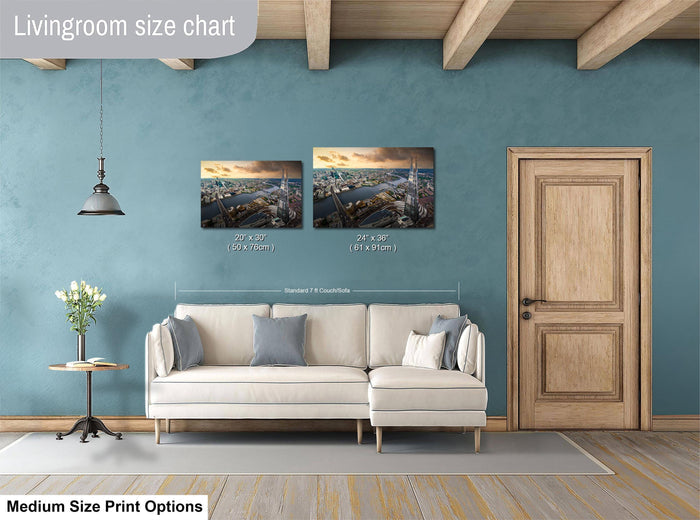 a living room with a white sofa, a wooden door, and a painting of a cityscape on the wall. The painting is of medium size, and the sofa is of standard size. The living room appears to be well-decorated with a potted plant and a vase.