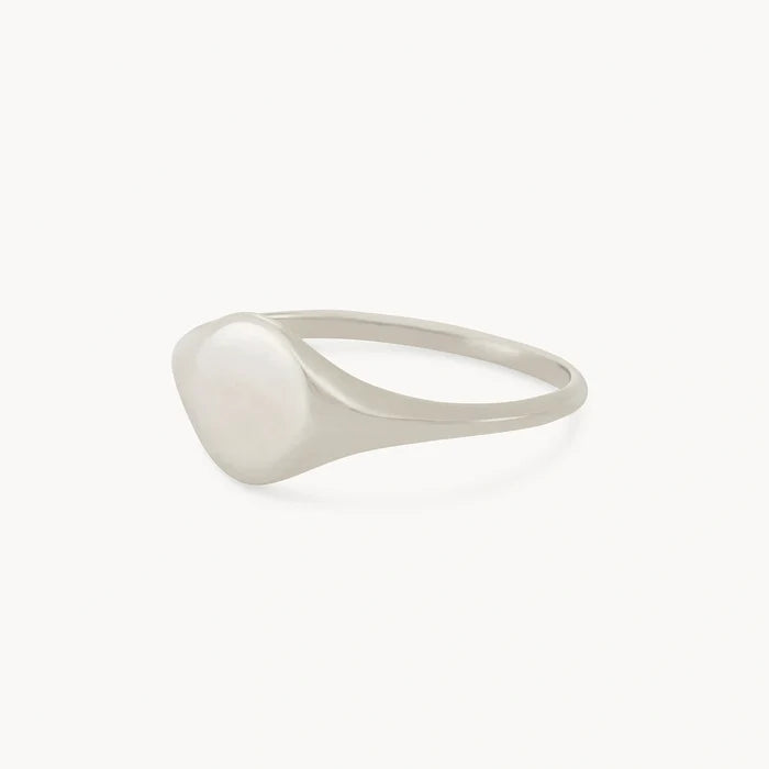 A sleek, polished silver signet ring from bluboho with a smooth, slightly domed surface on a white background. Named the Loyalty signet ring - sterling silver, engravable, it features a thin and elegant band that complements its minimalist design.