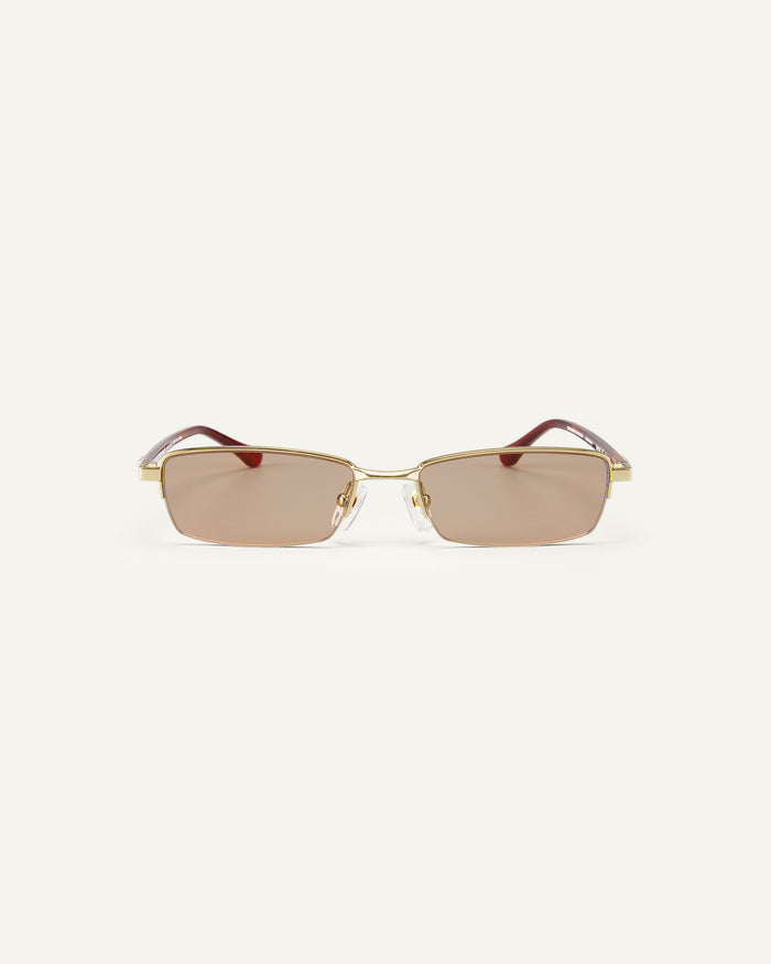 Face shot of Bonnie Clyde Lucky Star sunglasses in gold with brown lenses.