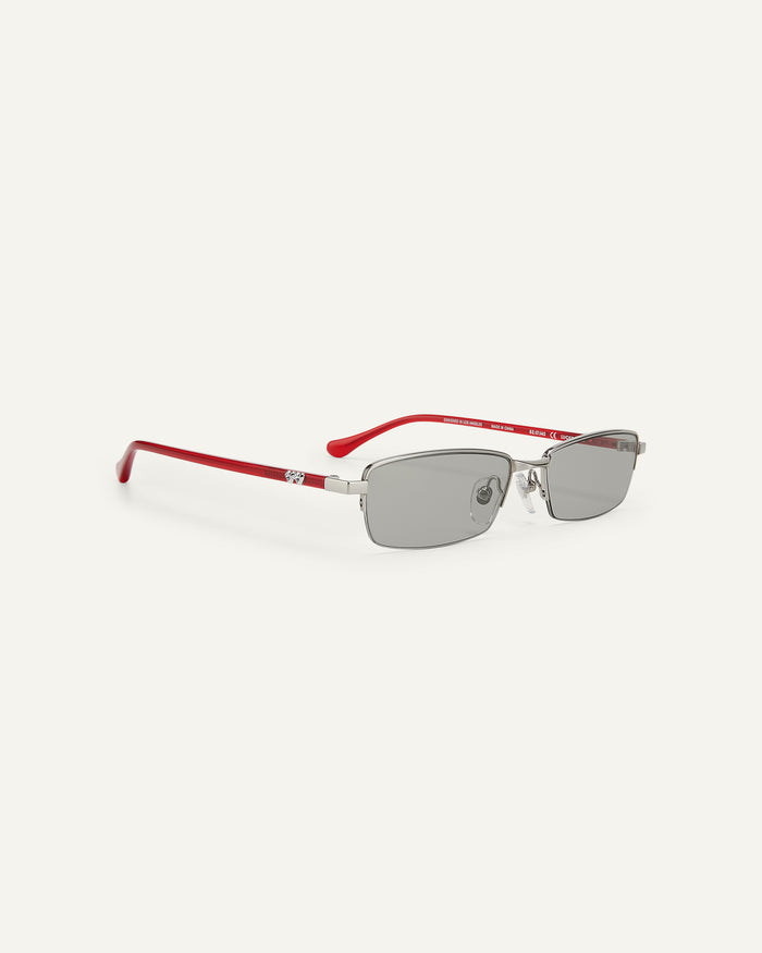 Quarter shot of Bonnie Clyde Lucky Star sunglasses in silver with grey lenses.
