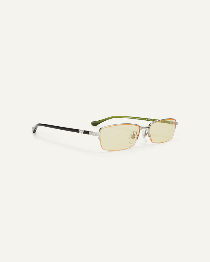 Quarter shot of Bonnie Clyde Lucky Star sunglasses in silver with yellow lenses.