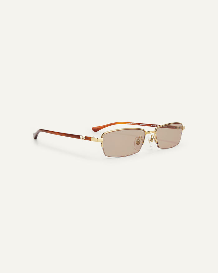 Quarter shot of Bonnie Clyde Lucky Star sunglasses in gold with brown lenses.
