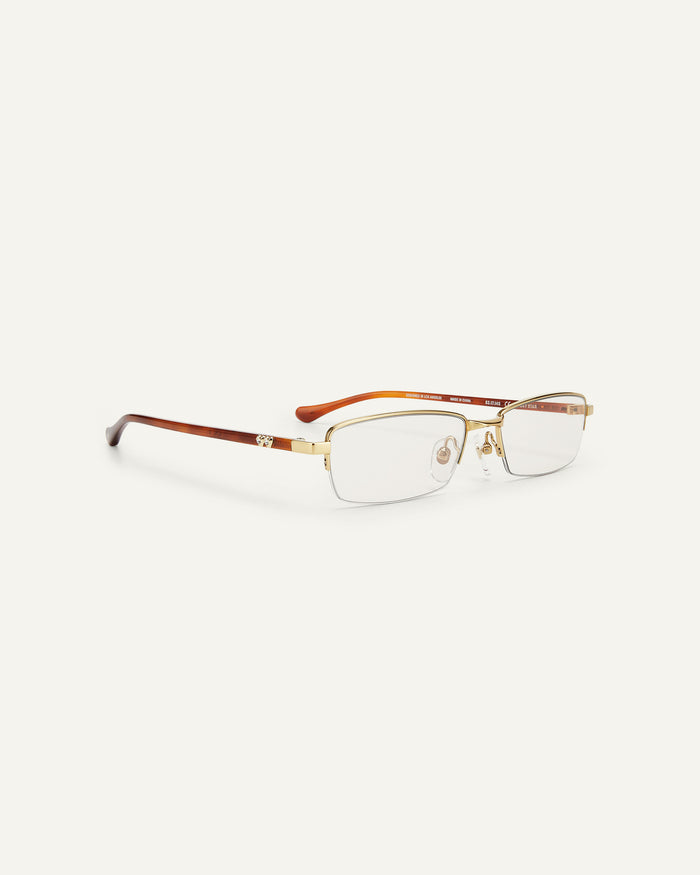 Quarter shot of Bonnie Clyde Lucky Star optical frames in gold with clear lenses.