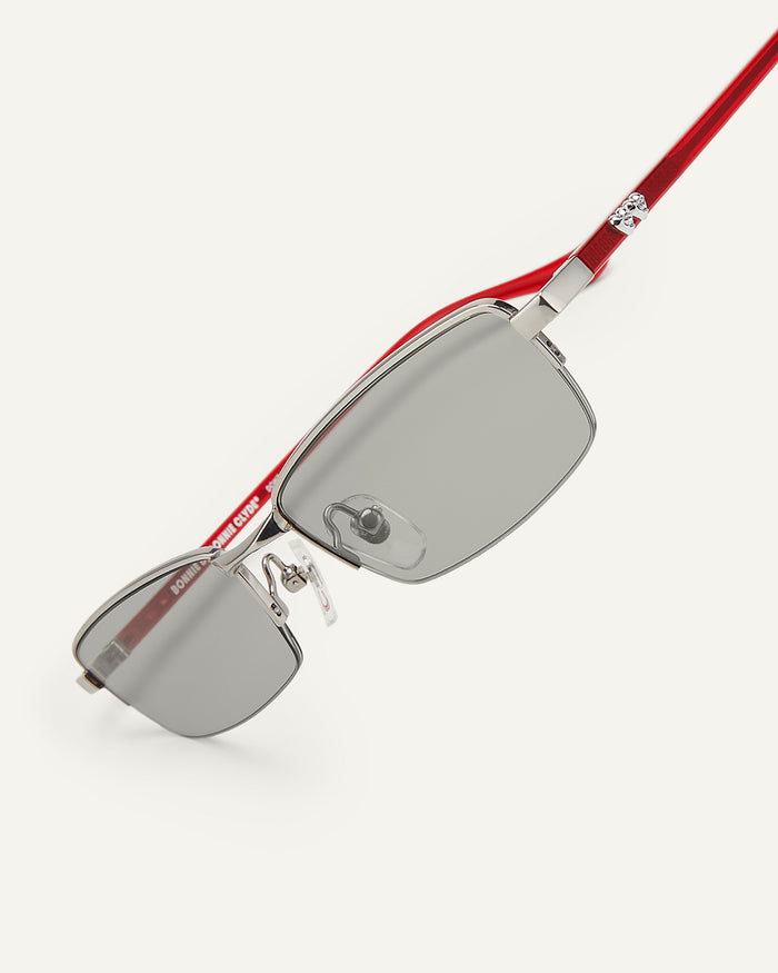Side shot of Bonnie Clyde Lucky Star sunglasses in silver with grey lenses.