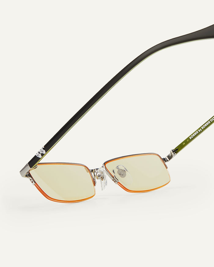 Side shot of Bonnie Clyde Lucky Star sunglasses in silver with yellow lenses.