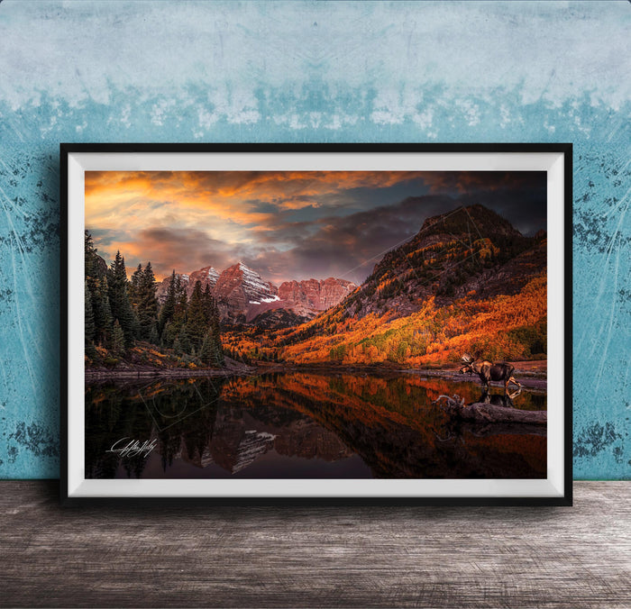 a serene mountain landscape with a lake reflecting the vibrant colors of the sky and surrounding trees.