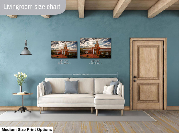 a living room with a white sofa, a wooden door, and a painting of a building on the wall. The painting is of a medium size, and the sofa is of a standard size. The living room appears to be well-decorated with a potted plant and a vase.