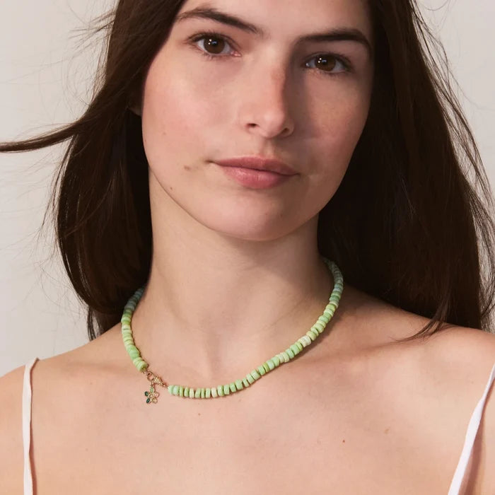 Meadow Forget-me-not Green Flower Charm in 10k yellow gold natural gemstones, shown worn on hand