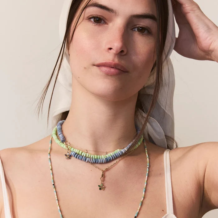 Meadow Forget-me-not Green Flower Charm in 10k yellow gold natural gemstones, shown worn on hand 2