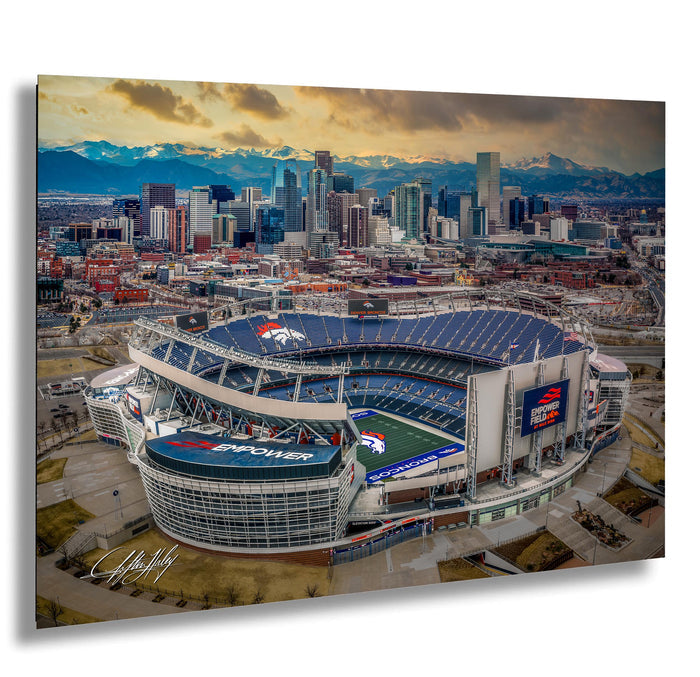 an aerial view of a large sports stadium, likely a football stadium, with the city skyline in the background.
