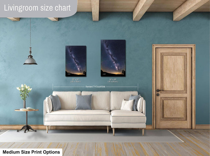 a living room with a white sofa, a wooden door, and a painting of a galaxy on the wall. The painting is of medium size, and the living room appears to be designed for a comfortable and relaxing atmosphere.
