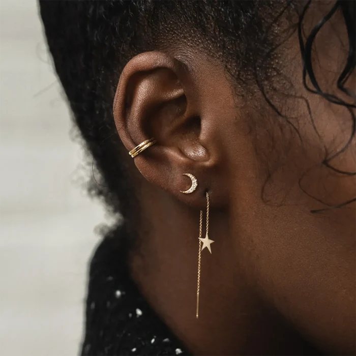 Moonlight Crescent Earring in 14k yellow gold, shown worn on hand