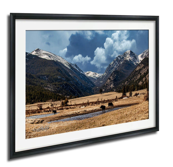 a serene landscape with a river flowing through a valley, surrounded by snow-capped mountains under a blue sky with clouds.