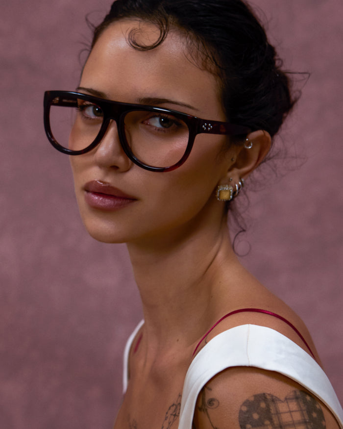 Quarter shot of Bonnie Clyde Moth optical frames in red tortoise with clear lenses.