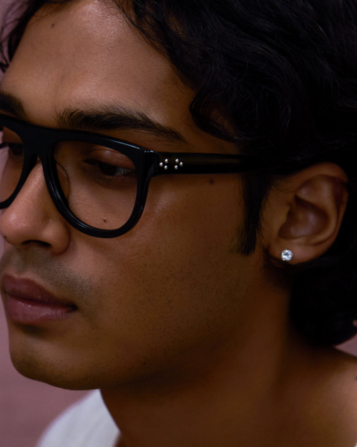 Quarter shot of Bonnie Clyde Moth optical frames in black with clear lenses.