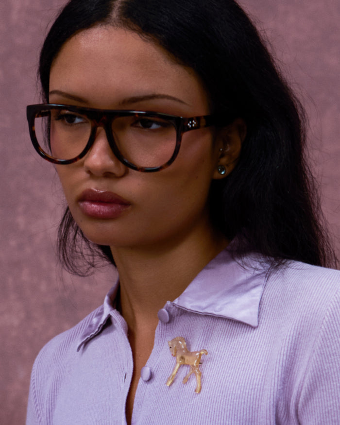 Quarter shot of Bonnie Clyde Moth optical frames in tortoise with clear lenses.