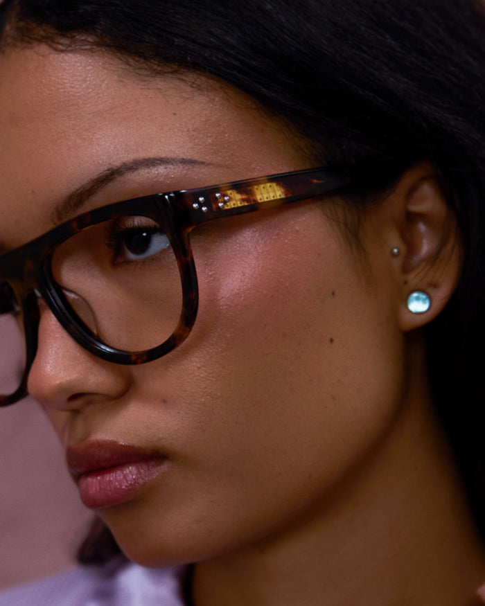 Close-up shot of Bonnie Clyde Moth optical frames in tortoise with clear lenses.