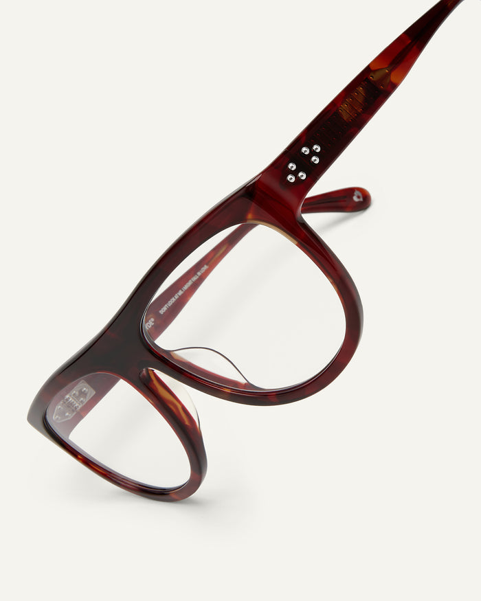 Detail shot of Bonnie Clyde Moth optical frames in red tortoise with clear lenses.