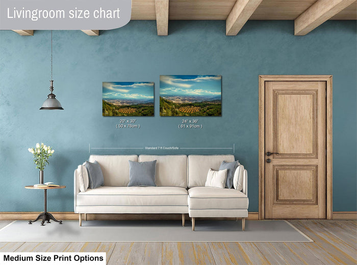 a living room with a white sofa, a wooden door, and a painting of a landscape on the wall. The living room appears to be well-lit and decorated with a potted plant and a vase.