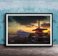 A framed photograph of the Mount Fuji, a famous landmark in Japan, with a red pagoda-style building in the foreground and a dramatic sky in the background.