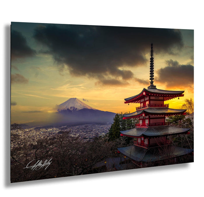 a majestic mountain range with a red pagoda-style temple in the foreground, set against a dramatic sky with clouds and a warm sunset glow.