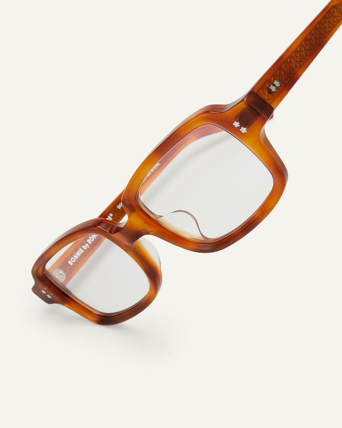 Close-up shot of Bonnie Clyde Mouse optical frames in yellow tortoise with clear lenses.