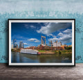 A framed photograph of the Nashville skyline, featuring the iconic skyline of Nashville, Tennessee, with the city's iconic landmarks such as the Tennessee State Capitol and the Nashville River.