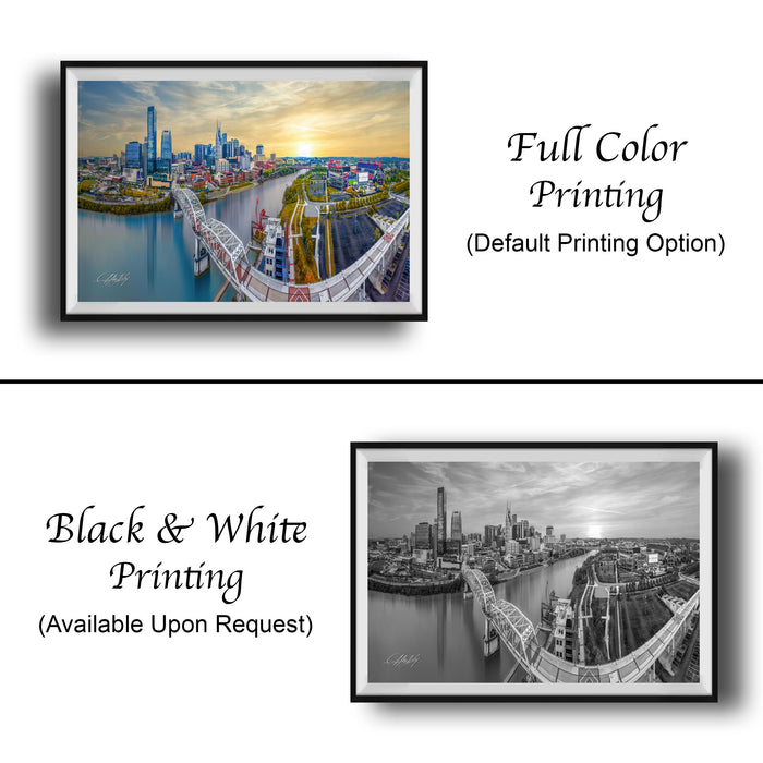 The image is a collage of two framed cityscape photographs. The top photograph is a full color print of a city skyline, while the bottom photograph is a black and white print of the same city skyline. Both prints are framed and available upon request.