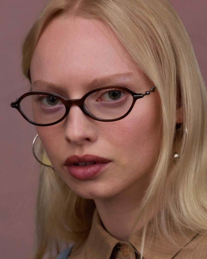 Quarter shot of Bonnie Clyde Nisa optical frames in silver and layered teal demi with clear lenses.