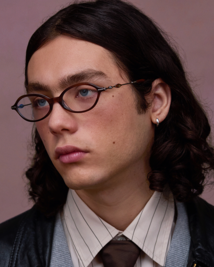 Close-up shot of Bonnie Clyde Nisa optical frames in silver and layered teal demi with clear lenses.