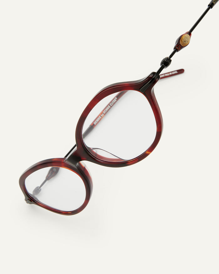 Close-up shot of Bonnie Clyde Nisa optical frames in black and red tortoise with clear lenses.