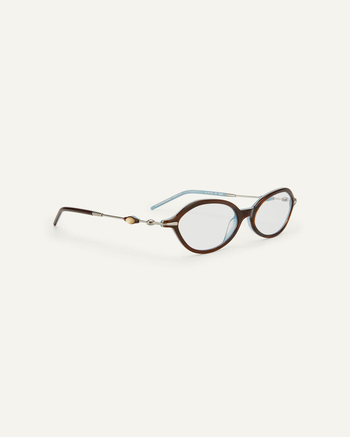 Detail shot of Bonnie Clyde Nisa optical frames in silver and layered teal demi with clear lenses.