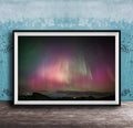 The image is a framed photograph of a night sky with the aurora borealis, or northern lights, visible.