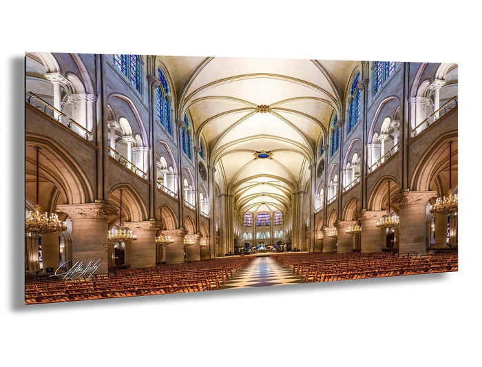 a grand cathedral with a high vaulted ceiling, ornate architectural details, and rows of wooden pews leading to a central altar.